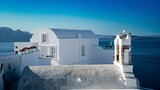 Beautiful view of a white church on a shoreline with the sea in the background in Santorini, Greece