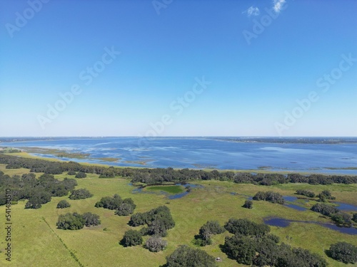 Top view of the lake Lake Tohopekaliga and surrounding fields in Florida photo