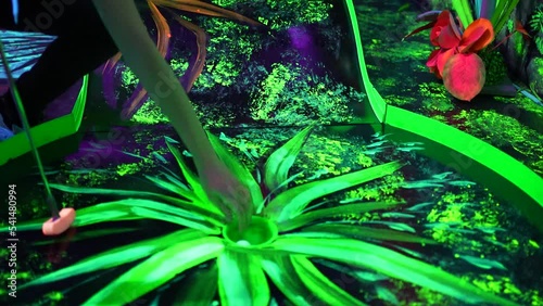 Reaching for and taking the golf ball at a jungle patterned pitch