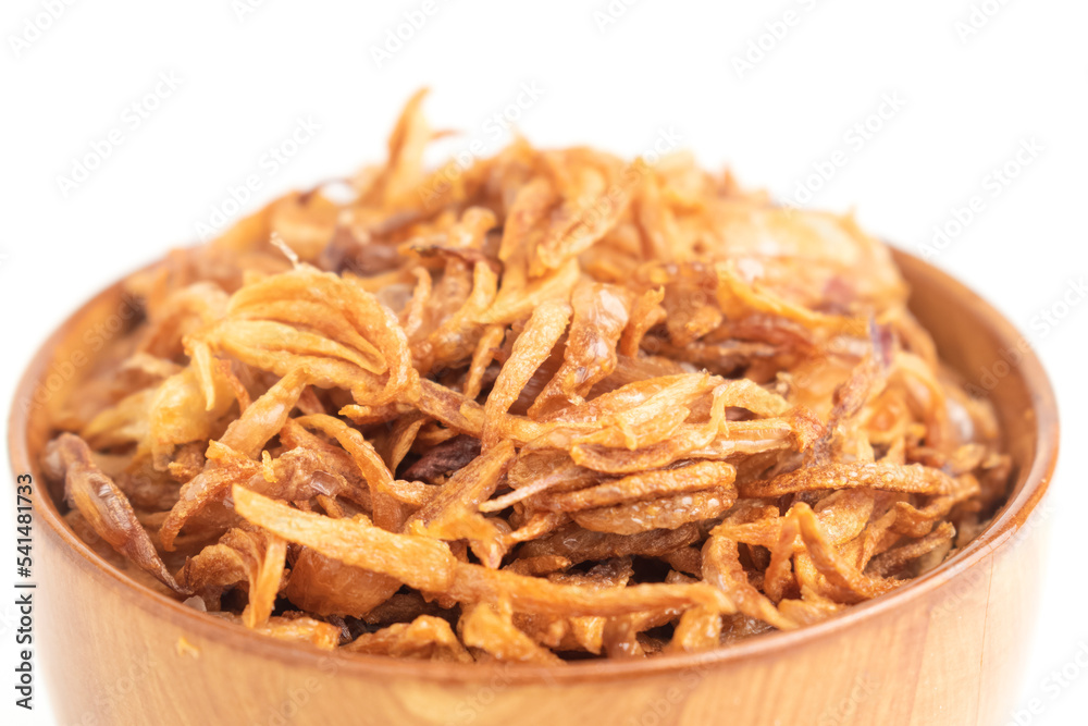 deep fried crispy shallot for garnishing on wooden bowl isolated on white background deep fried crispy shallot for garnishing on wooden bowl isolated on white background