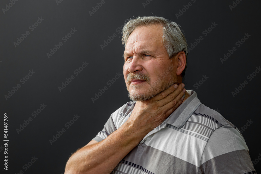 Adult man with sore throat on black background Adult man with sore throat on black background