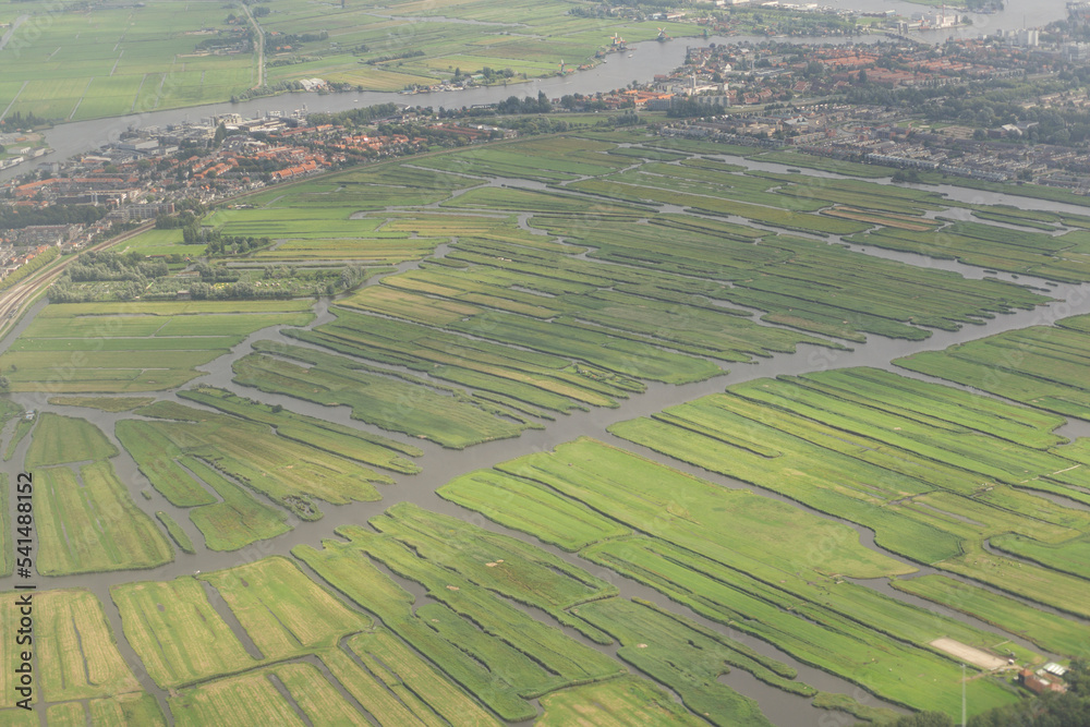 Famous polder fields at amsterdam city viewed from an airplane on sunny day with Amstel river at background Famous polder fields at amsterdam city viewed from an airplane on sunny day with Amstel river at background