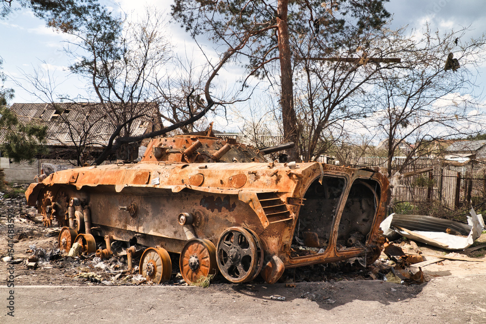 A burnt armored personnel carrier of russians in a village near Kyiv