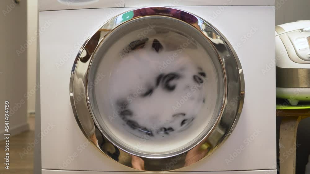 The washing machine does the Laundry. Closeup of the drum spinning