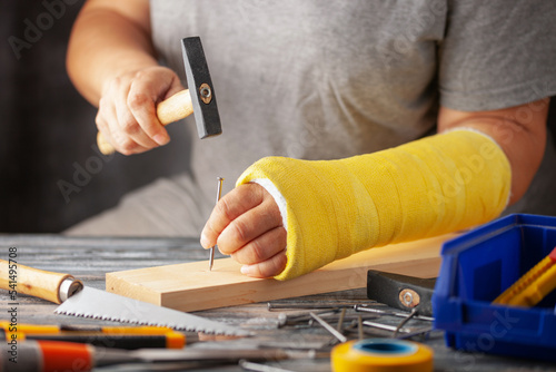 Wallpaper Mural Broken arm. Hand in plaster and building tools Torontodigital.ca