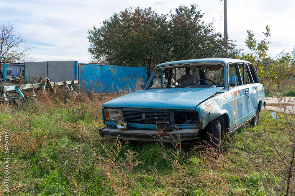 War in Ukraine. 2022 Russian invasion of Ukraine. Countryside. A destroyed civilian car stands on the side of the road. Holes from bullets and splinters on the body of the car War in Ukraine. 2022 Russian invasion of Ukraine. Countryside. A destroyed civilian car stands on the side of the road. Holes from bullets and splinters on the body of the car