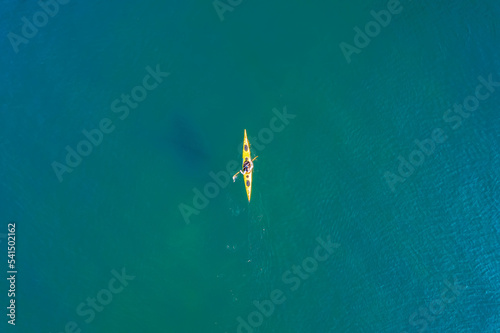 Red or yellow kayak with man sea, open space, aerial top view