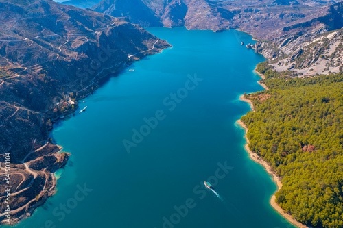 Green Canyon Turkey with travel ship, Manavgat Mountain Lake Aerial top view