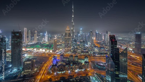 Wallpaper Mural Aerial panoramic view of tallest towers in Dubai Downtown skyline and highway day to night transition timelapse. Financial district and business area in smart urban city. Skyscraper and high-rise Torontodigital.ca