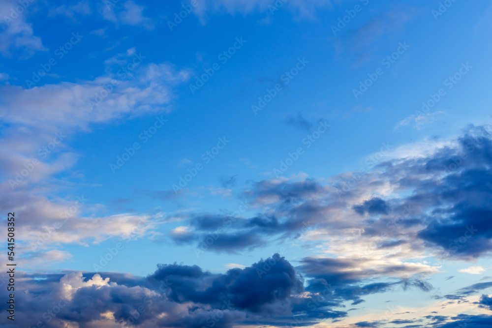 Gray fluffy clouds in the light blue sky Gray fluffy clouds in the light blue sky