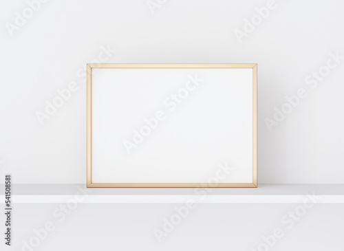 Interior poster mockup with horizontal golden metal frame on white wall. A4, A3 size format. 3D rendering, illustration.