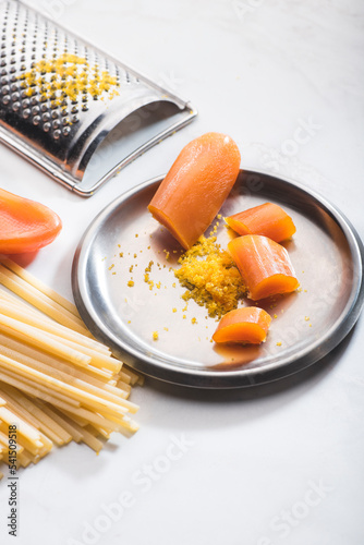 Wallpaper Mural Bottarga, dried roe of mullet or tuna eggs,  with grater  and pasta on the white background.  Sardinian  and Sicilian recipe. Pasta with bottarga Torontodigital.ca