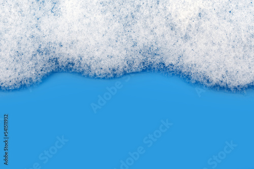 Soap foam. Background of dusty foam with bubbles of blue color for an inscription. Soap sud with copy-space