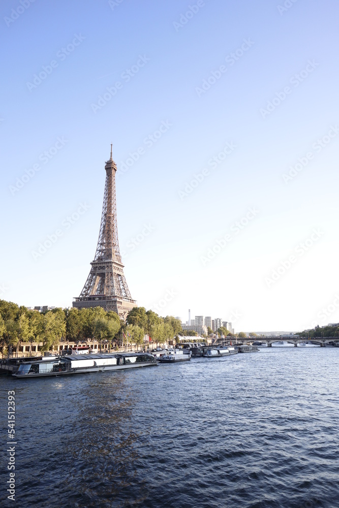 Portrait view on the Eiffel tower and Seine river during a sunny day in Paris, France