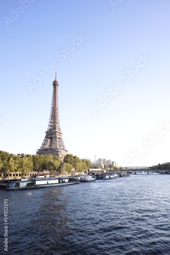 Portrait view on the Eiffel tower and Seine river during a sunny day in Paris, France