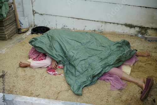 Dead woman lay down under bag covered death body from accident or murder at house of victim with evidence. Horror scene for Halloween.