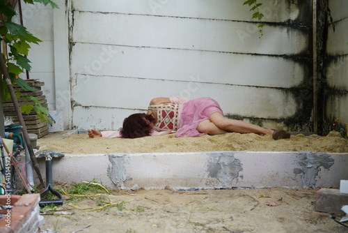 Dead woman lay down under bag covered death body from accident or murder at house of victim with evidence. Horror scene for Halloween.