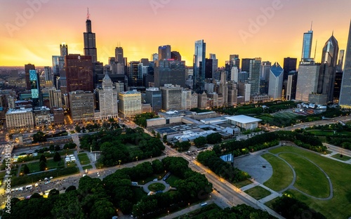 Aerial view of Chicago Downtown with high skyscrapers at sunset in cloudy sky background