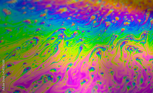 Photo of iridescent surface of soapy water. Space, halographic, psychedelic background for screensaver. photo