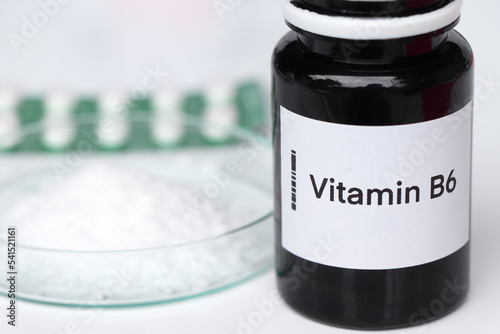 Vitamin B6 pills in a bottle, food supplement or used to treat disease photo