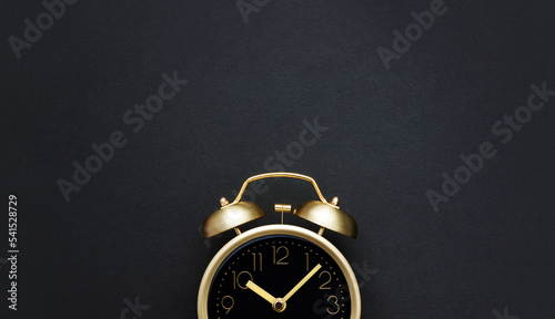 Wallpaper Mural Golden vintage alarm clock on a black background. Black Friday time. Selective focus, copy space Torontodigital.ca