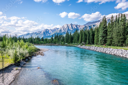 A beautiful photo of river in Canmore, Alberta with the rocky mountains in the background.  photo