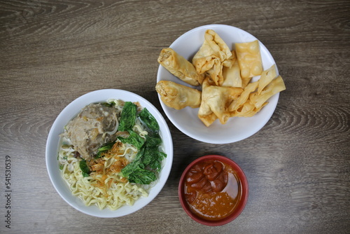 Indonesian street food. Chicken noodles in a bowl. Top view.