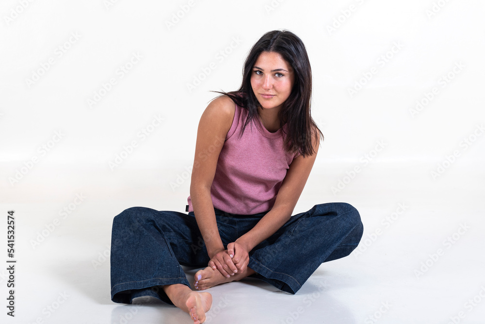 Beautiful young woman wearing a pink t-shirt, looking at camera over white background. Beautiful young woman wearing a pink t-shirt, looking at camera over white background.