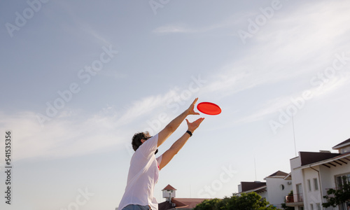 Man catching Frisbee. Game of Frisbee. Beach activities. Time for relaxation. Summer entertainment
