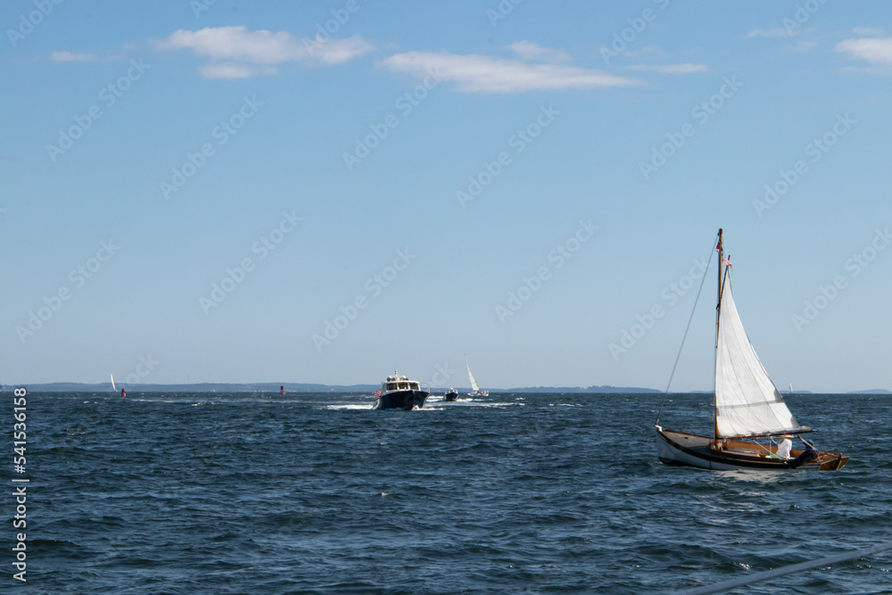 Fototapeta premium Sailboat and motorboat in the ocean