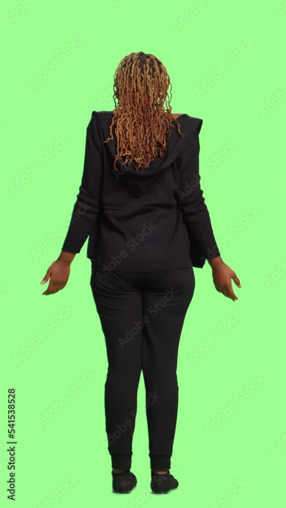 Vertical video: Woman doing i dont know uncertain sign with full body over isolated greenscreen background, back view. Showing doubt with confused symbol, standing over green screen backdrop. Vertical video: Woman doing i dont know uncertain sign with full body over isolated greenscreen background, back view. Showing doubt with confused symbol, standing over green screen backdrop.