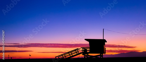 Sunset behind a lifeguard tower on the beach in Los Angeles, CA. 