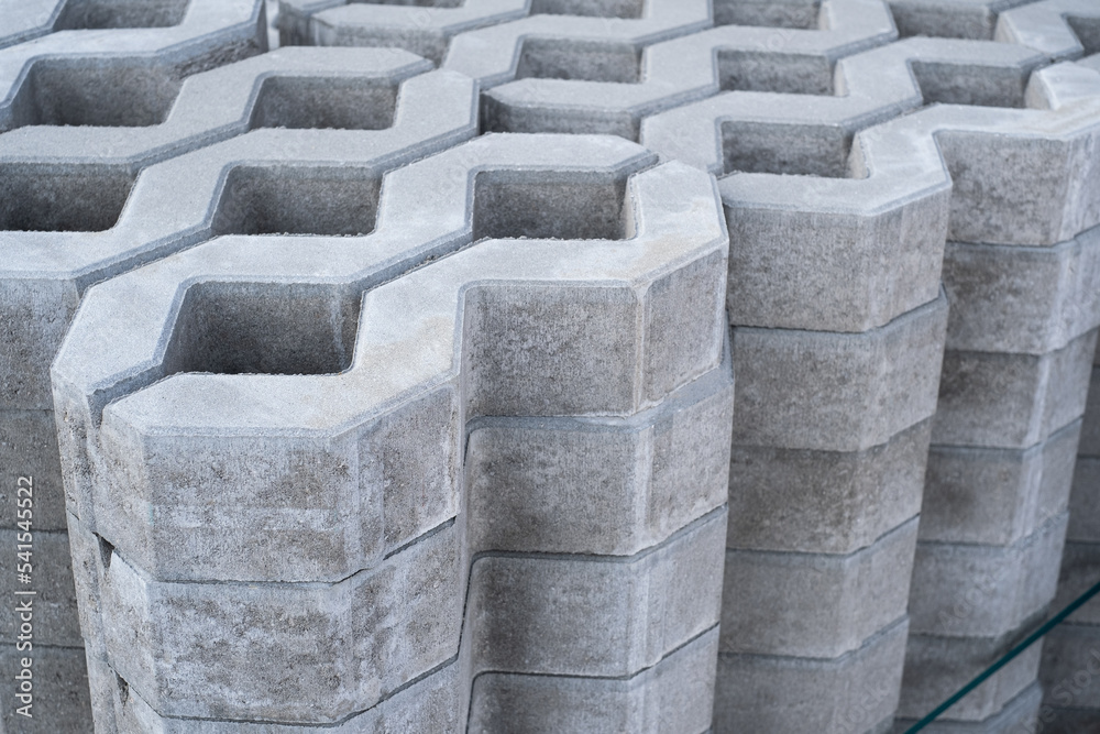 New checkered Concrete Cinder tiles of a garden sidewalk lawn in palette in store. New checkered Concrete Cinder tiles of a garden sidewalk lawn in palette in store.