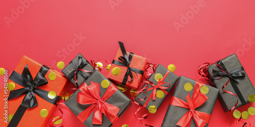 Many gift boxes on red background  top view