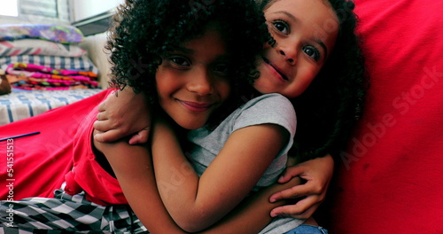 Brazilian little girls hugging and smiling. Cute sisters