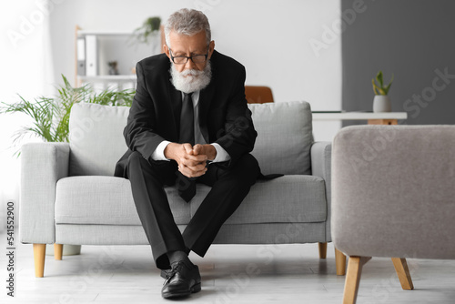 Thoughtful mature man sitti...