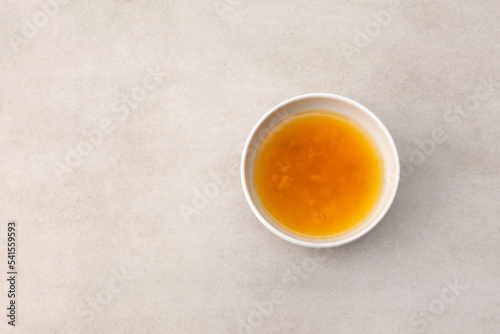 Yuzu tea or Yuja cha on stone table, top view. Popular Korean tea. Honey citron beverage. Healthy drink photo