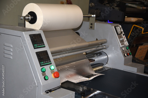 Electric industrial laminator for applying film to paper in the production shop © Шамиль Алиев