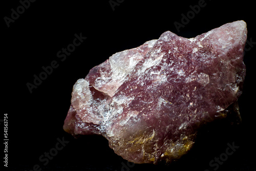 Close-up macro pink aventurine, strawberry quartz raw crystal stone, pink quartz with lepidolite mica inclusions isolated on a black background surface 