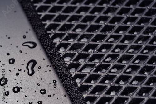 Fotografiet Close up view of a new all season eva car mat with water drops.