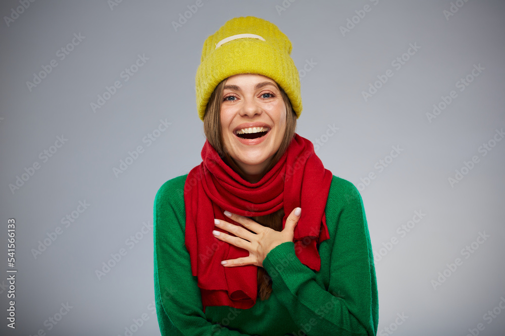 Happy surprising woman in casual warm clothes. Advertising female studio portrait.