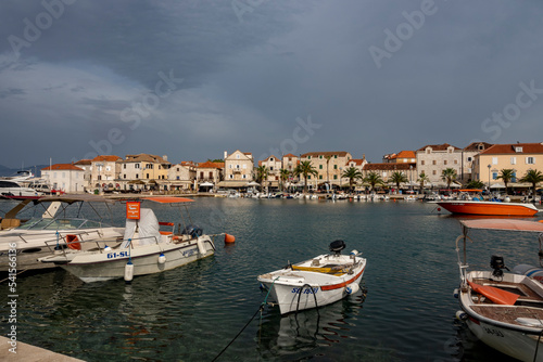 Beautiful stone houses at the town of Supetar, Croatia, located on Brac island with approaching storm in distance
