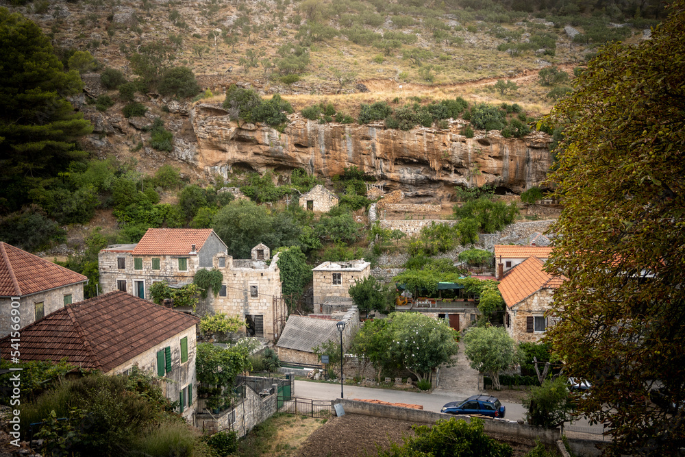 Beautiful old houses with garden with cultivated plants in the village of Dol on Brac island, Croatia