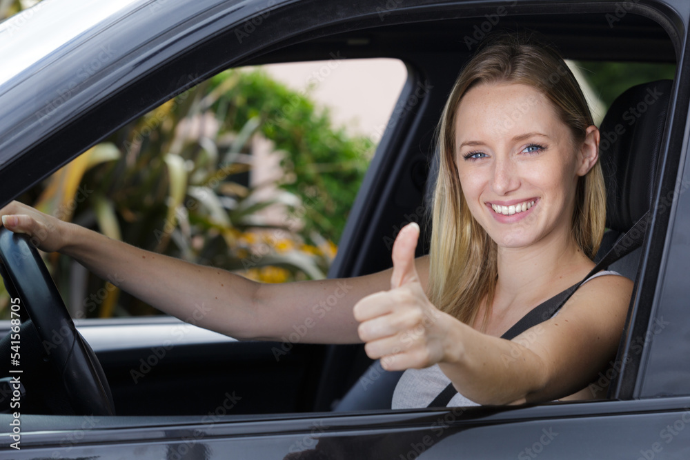 female driver showing ok sign