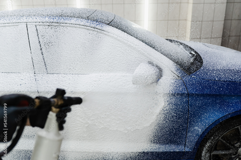 Process of spraying foam on the car body in the garage. Second phase of