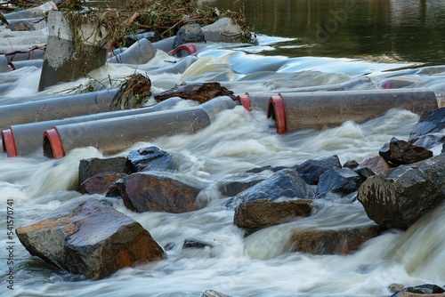 : Concrete pipes from a temporary river crossing after a flood. Becva. Moravia. Czechia.  photo