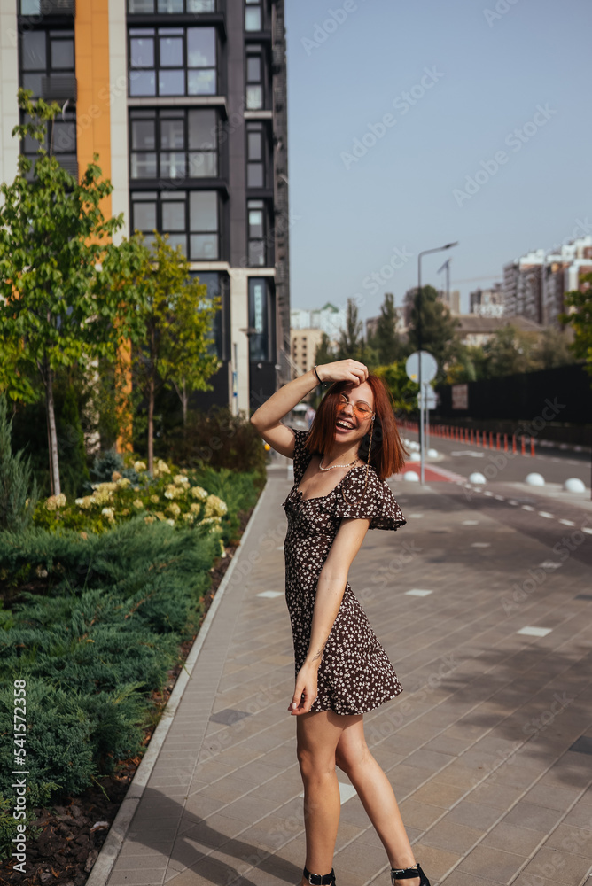 Young pretty trendy girl posing at the city in Europe