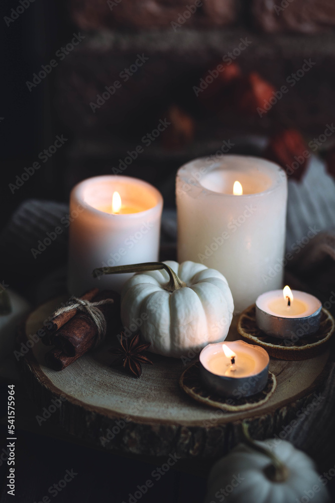 Autumn home composition with aromatic candle, dry citrus, cinnamon, anise. Aromatherapy on a grey fall morning, atmosphere of cosiness and relax. Wooden background close up copy space Autumn home composition with aromatic candle, dry citrus, cinnamon, anise. Aromatherapy on a grey fall morning, atmosphere of cosiness and relax. Wooden background close up copy space