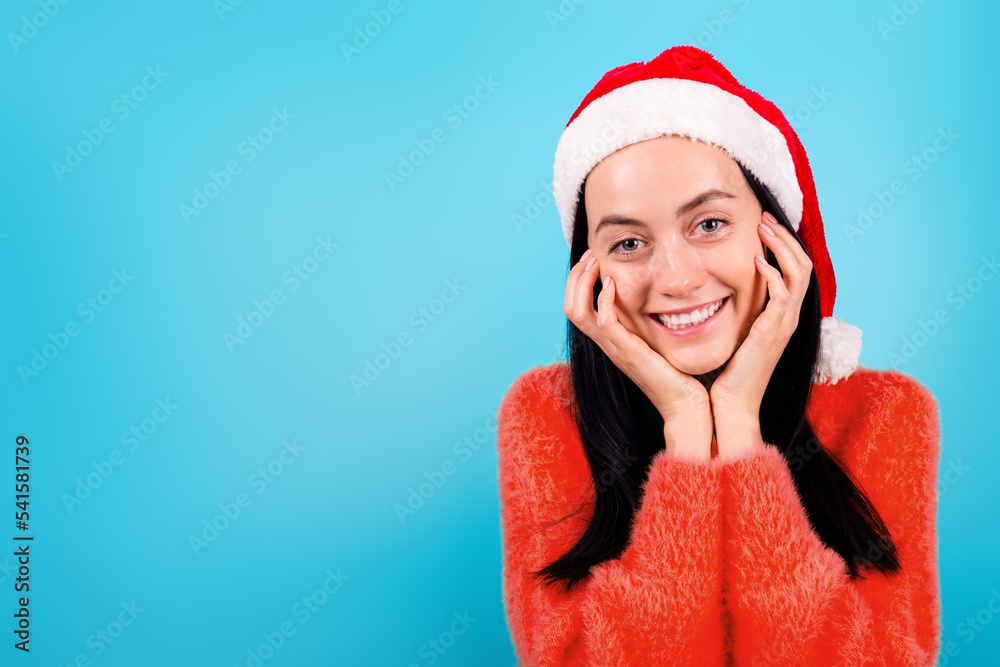 Photo of charming cute lady arms touch cheekbones festive in Santa hat on isolated blue color background
Photo of charming cute lady arms touch cheekbones festive in Santa hat on isolated blue color background