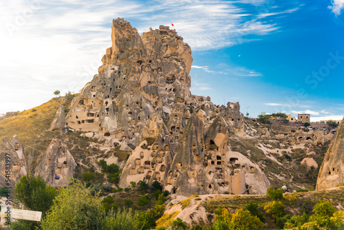 Cappadocia - historical region in Central Anatolia. Beautiful weather with sunshine and blue sky. Cave towns in original rock formations. High quality photo